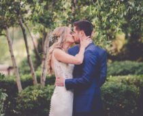 bride and groom kissing at alter